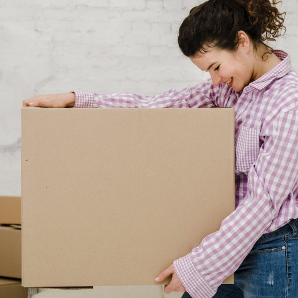 cheerful-woman-carrying-box